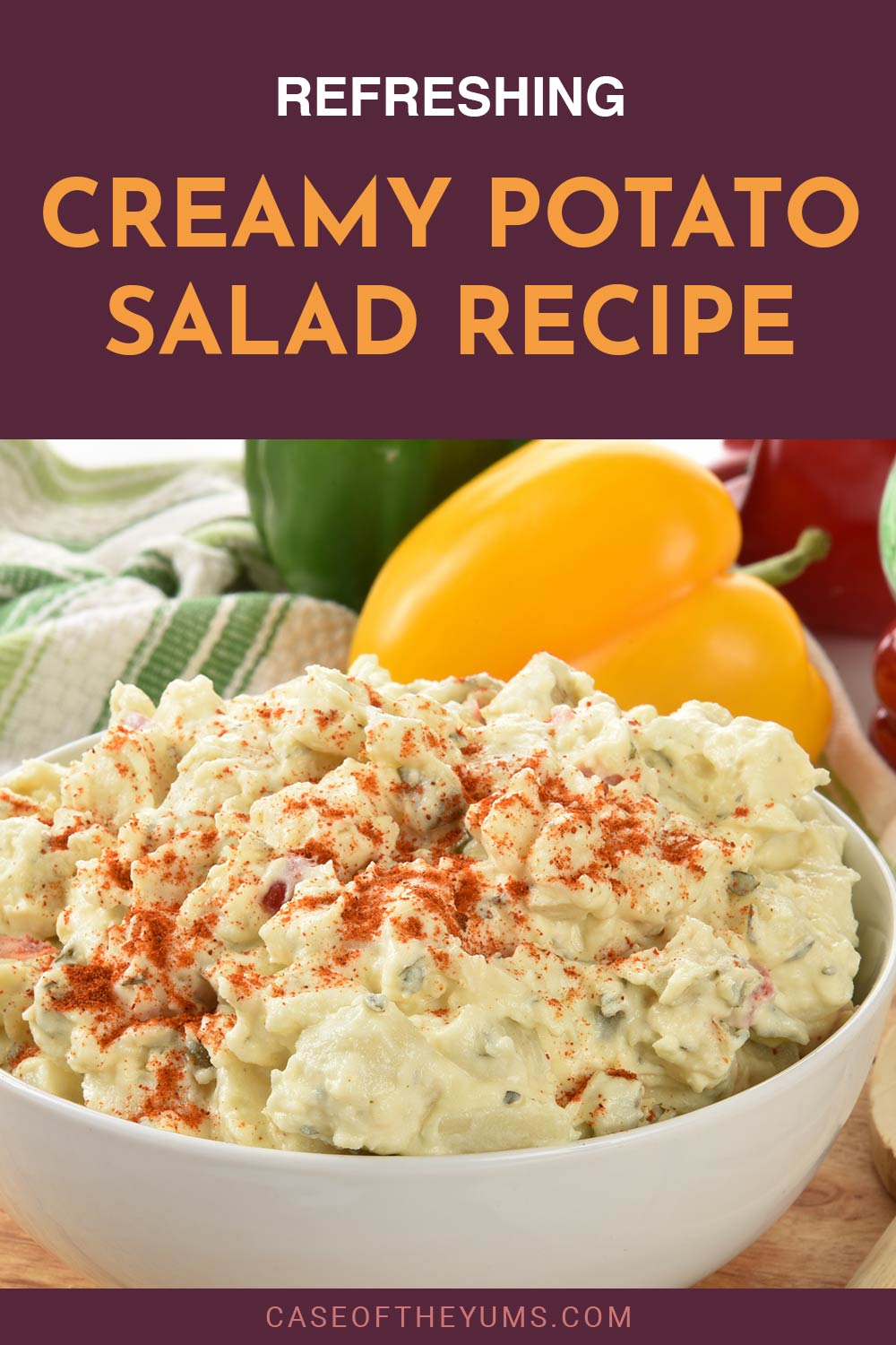 A white bowl full of smashed potato on wooden surface and capsicums besde it - Refreshing Creamy Potato Salad Recipe.